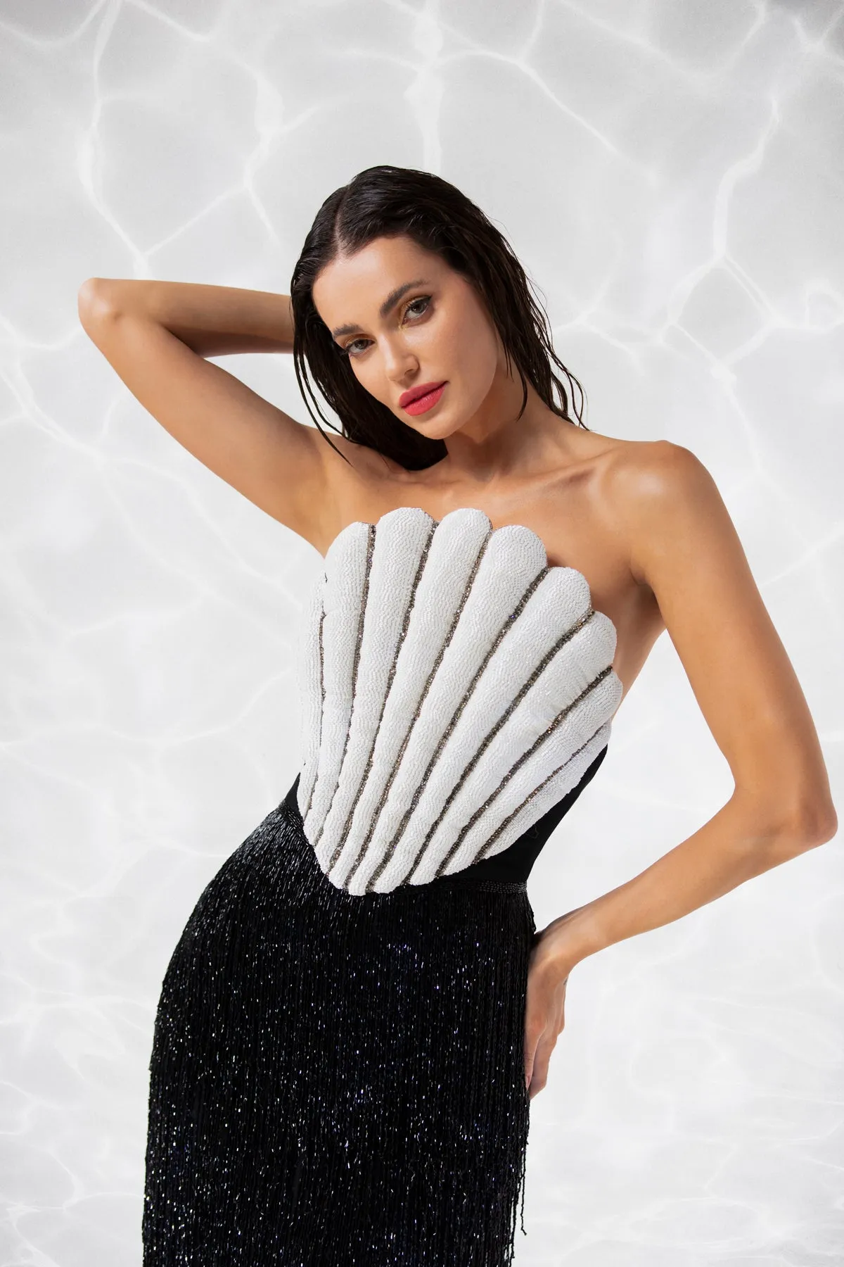 Scallop shell inspired dress consisting of a bustier embroidered with crystals and glass beads, a skirt in hanging beaded fringes