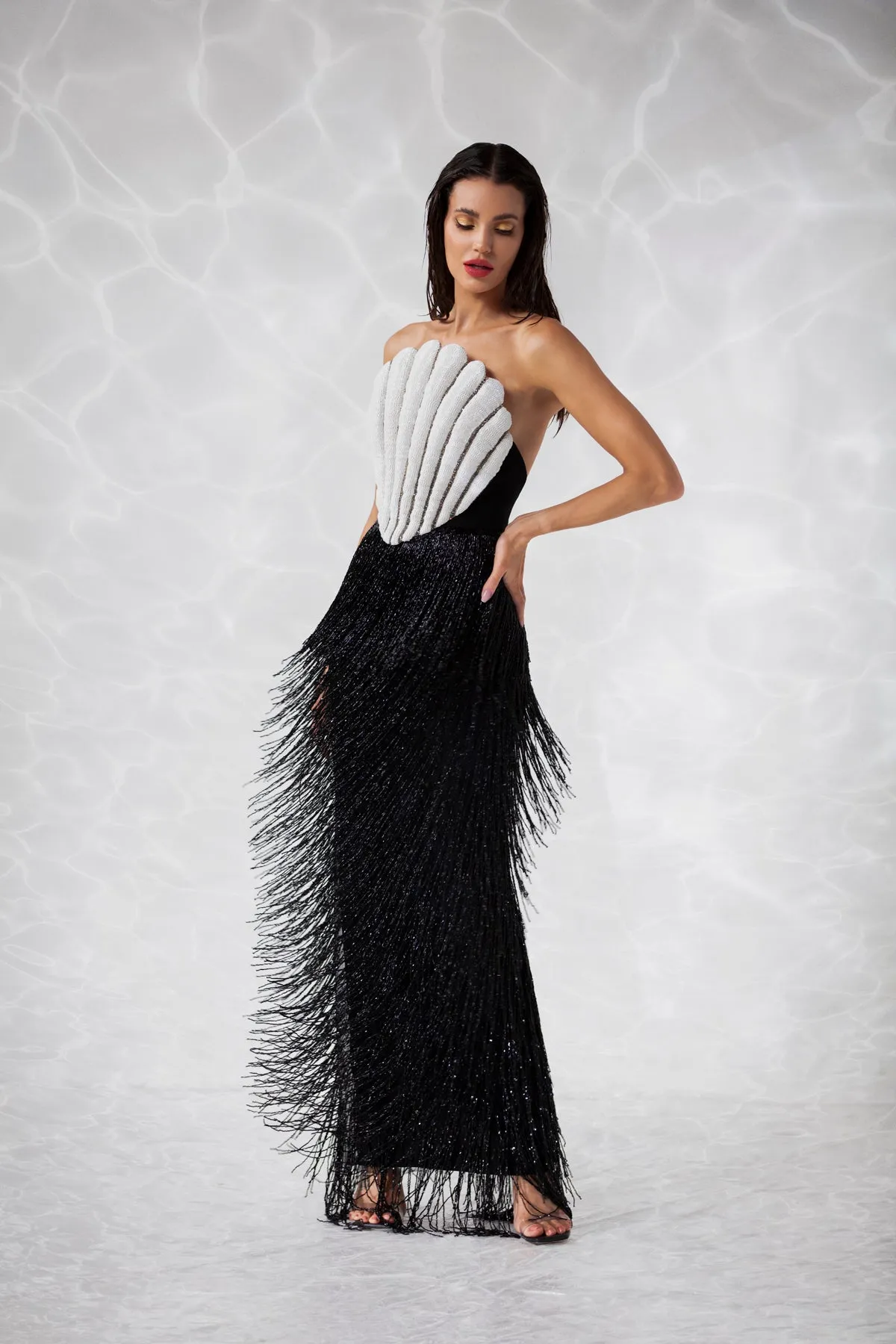 Scallop shell inspired dress consisting of a bustier embroidered with crystals and glass beads, a skirt in hanging beaded fringes